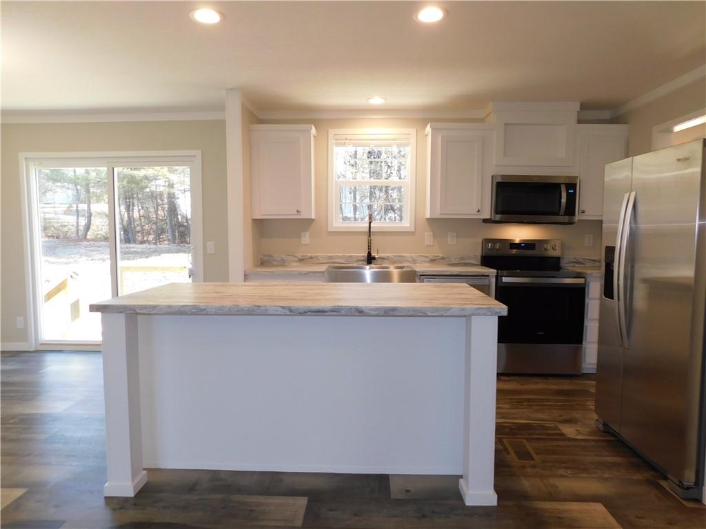 350 Galahad Road Dahlonega, GA 30533 - Photo 15 of 39 a kitchen with kitchen island granite countertop a stove a sink and a refrigerator