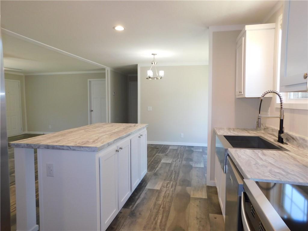 350 Galahad Road Dahlonega, GA 30533 - Photo 19 of 39 a kitchen with granite countertop a sink and a stove
