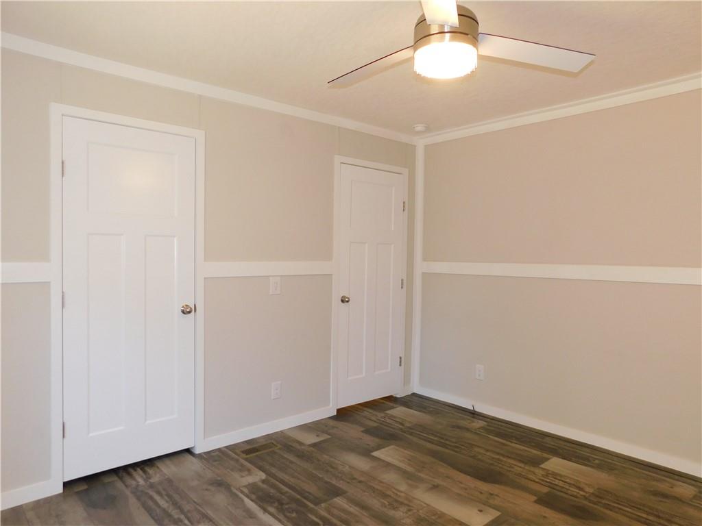 350 Galahad Road Dahlonega, GA 30533 - Photo 24 of 39 a view of an empty room with wooden floor and a window