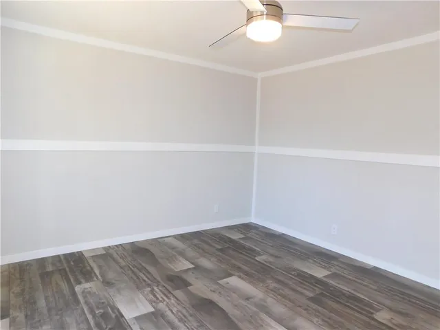 a bathroom with a granite countertop toilet sink and mirror