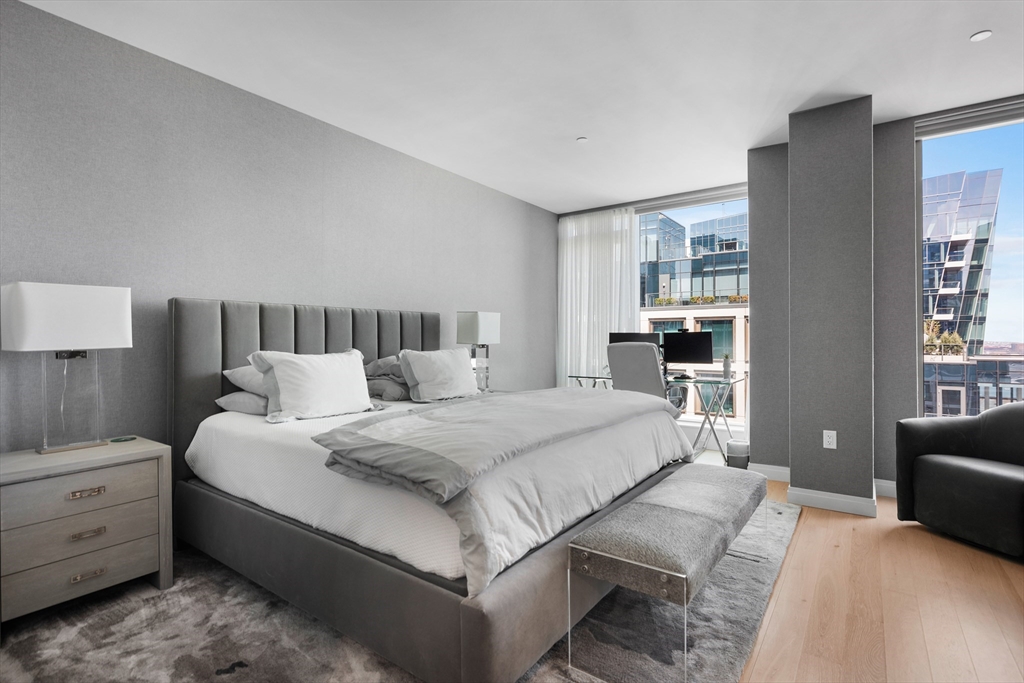 135 Seaport Boulevard, Unit 1902 Boston, MA 02210 - Photo 15 of 40 a spacious bedroom with a bed and a couch