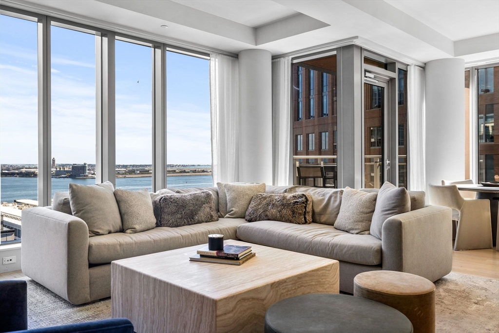 135 Seaport Boulevard, Unit 1902 Boston, MA 02210 - Photo 2 of 40 a living room with furniture and a large window