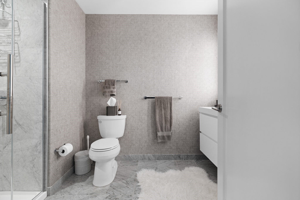 135 Seaport Boulevard, Unit 1902 Boston, MA 02210 - Photo 21 of 40 a white toilet sitting next to a bathroom sink