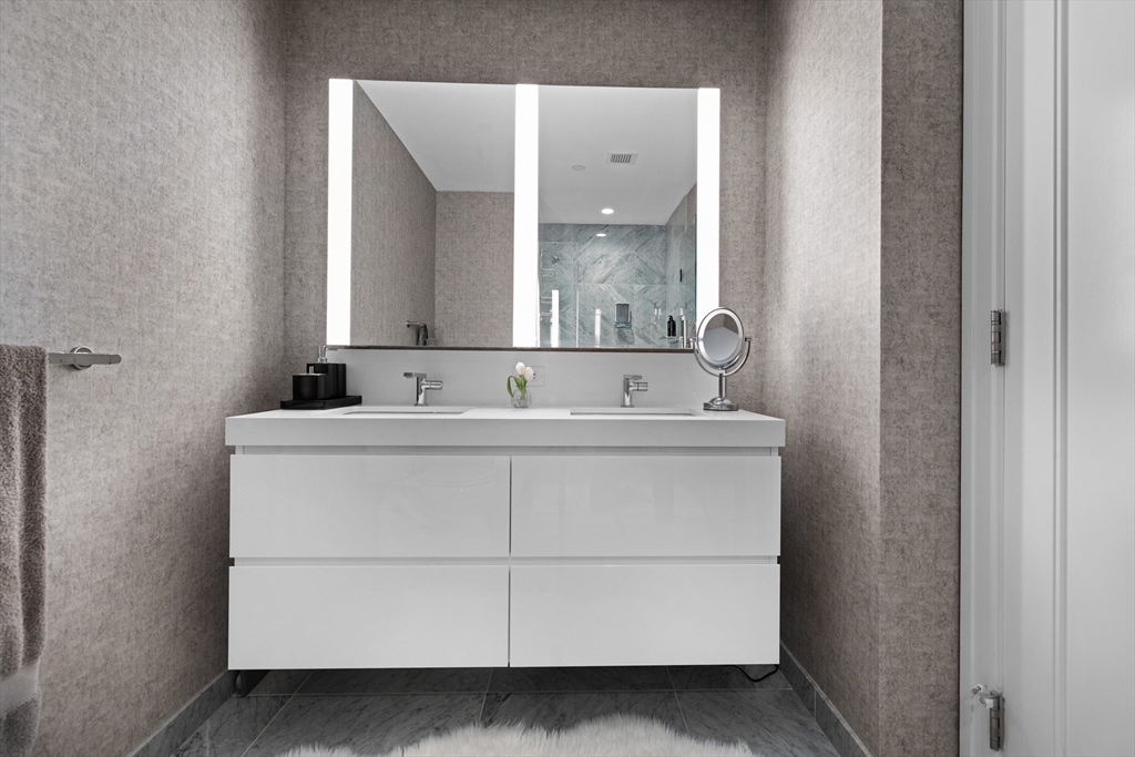 135 Seaport Boulevard, Unit 1902 Boston, MA 02210 - Photo 23 of 40 a bathroom with a sink and a mirror
