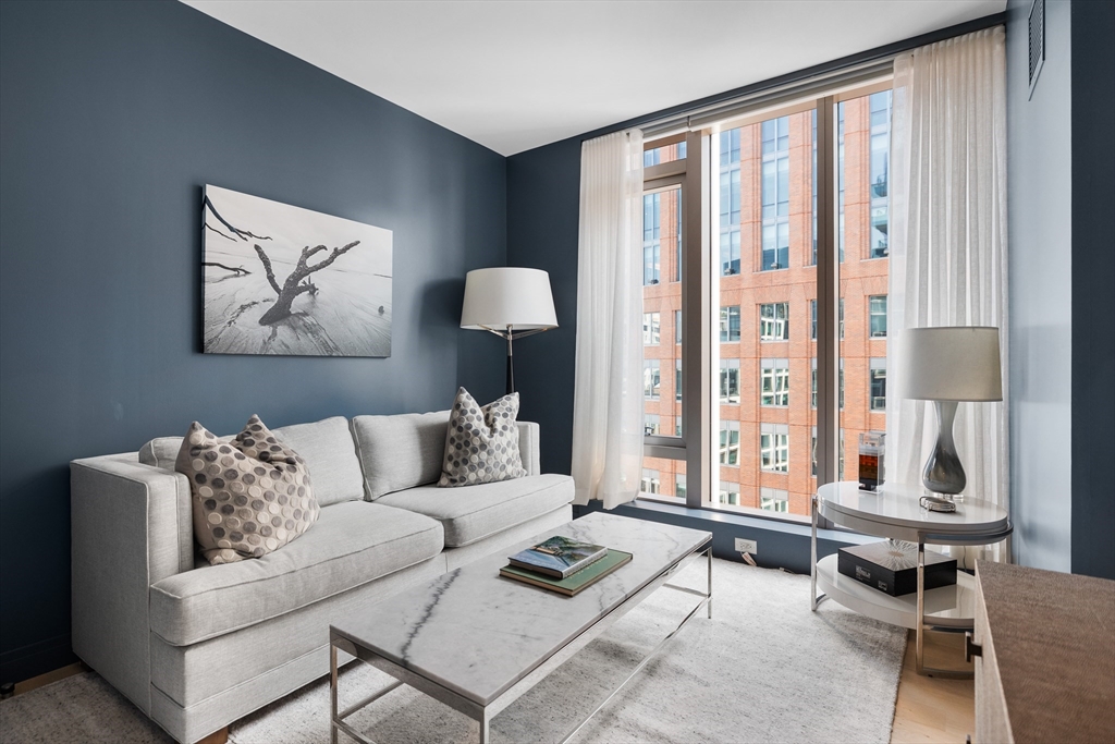 135 Seaport Boulevard, Unit 1902 Boston, MA 02210 - Photo 26 of 40 a living room with furniture and a large window
