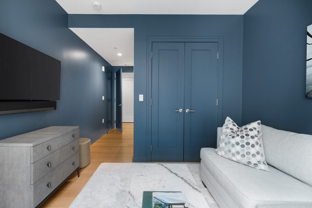 135 Seaport Boulevard, Unit 1902 Boston, MA 02210 - Photo 27 of 40 a bedroom with a bed and a flat screen tv