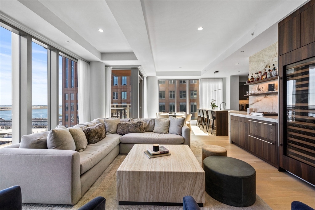 135 Seaport Boulevard, Unit 1902 Boston, MA 02210 - Photo 3 of 40 a living room with furniture and a large window