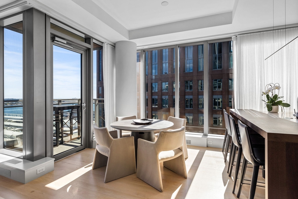 135 Seaport Boulevard, Unit 1902 Boston, MA 02210 - Photo 4 of 40 a dining room with furniture and large windows