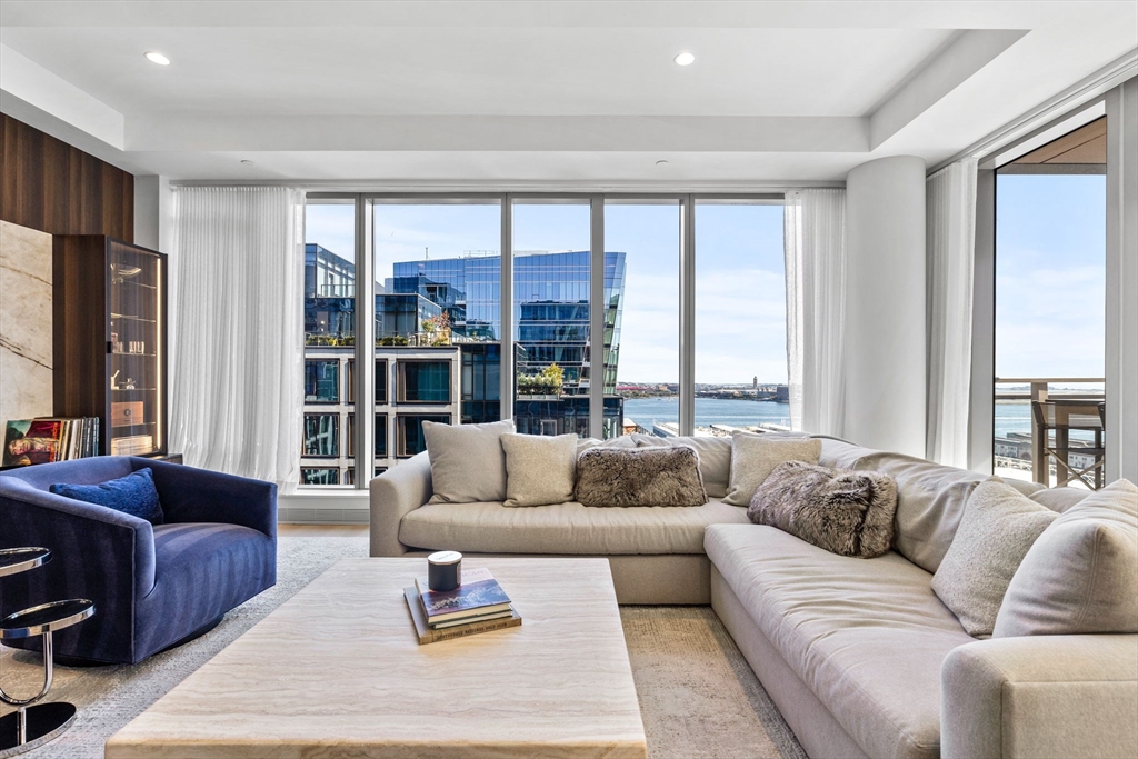 135 Seaport Boulevard, Unit 1902 Boston, MA 02210 - Photo 7 of 40 a living room with furniture and a large window