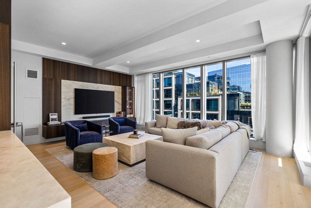 135 Seaport Boulevard, Unit 1902 Boston, MA 02210 - Photo 8 of 40 a living room with furniture and a flat screen tv