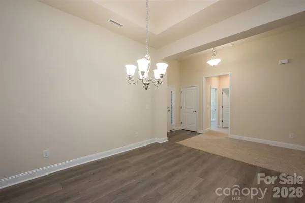a view of an empty room with a fireplace and a window