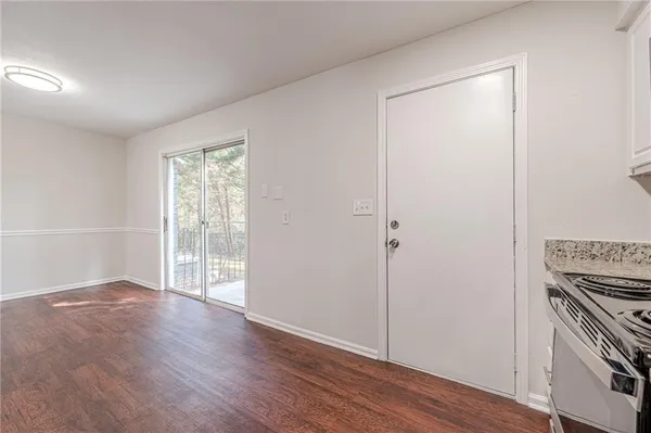 an empty room with wooden floor and a window