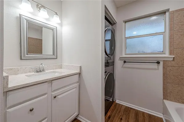 a bathroom with a granite countertop sink vanity and mirror