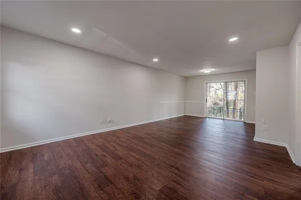 a view of wooden floor and windows in an empty room