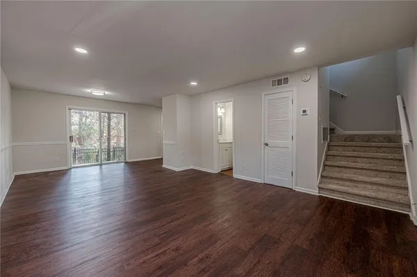 a view of wooden floor and windows in an empty room