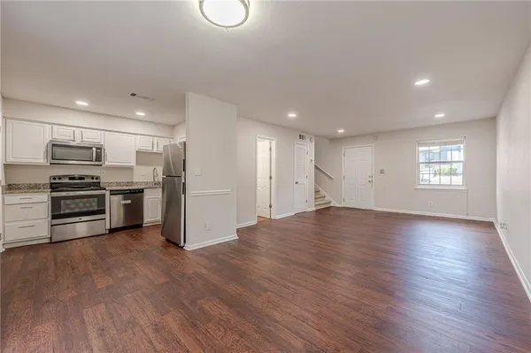 a view of kitchen with kitchen island microwave and stove