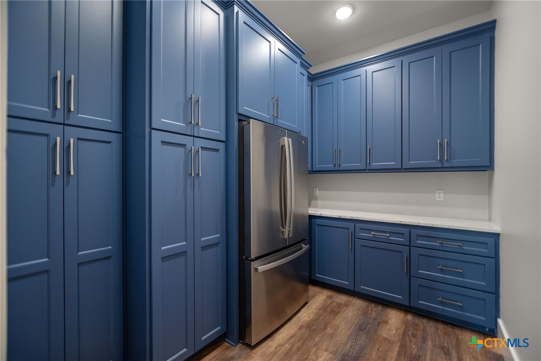 2062 Harrison Avenue Port O'Connor, TX 77982 - Photo 13 of 48 a kitchen with stainless steel appliances granite countertop wood cabinets and refrigerator