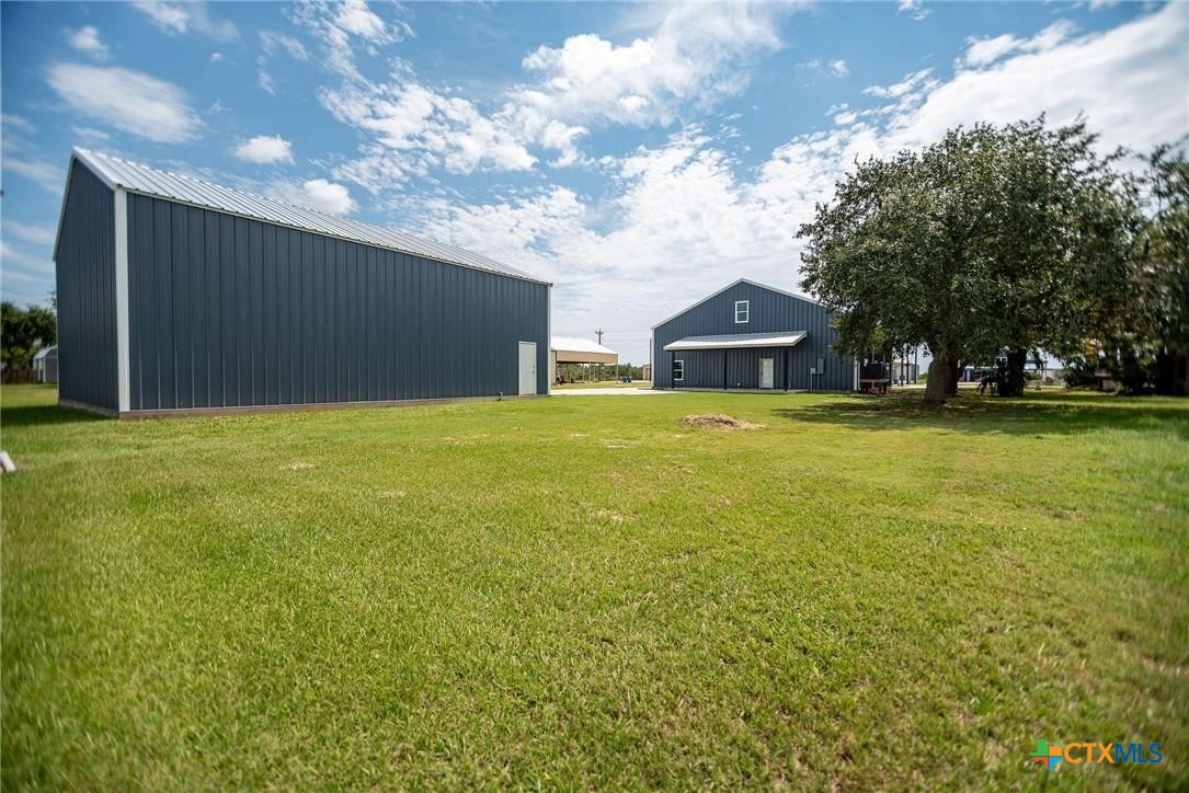 2062 Harrison Avenue Port O'Connor, TX 77982 - Photo 20 of 48 a view of a large pool with a big yard and a large tree