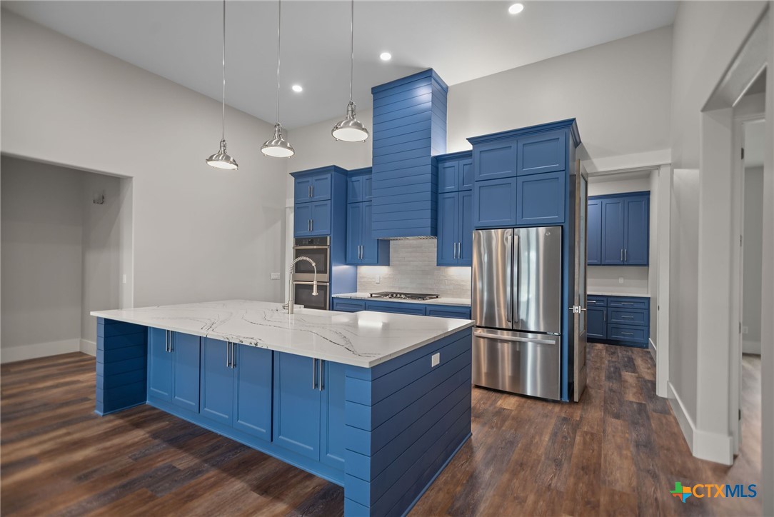 2062 Harrison Avenue Port O'Connor, TX 77982 - Photo 2 of 48 a kitchen with wooden cabinets and stainless steel appliances