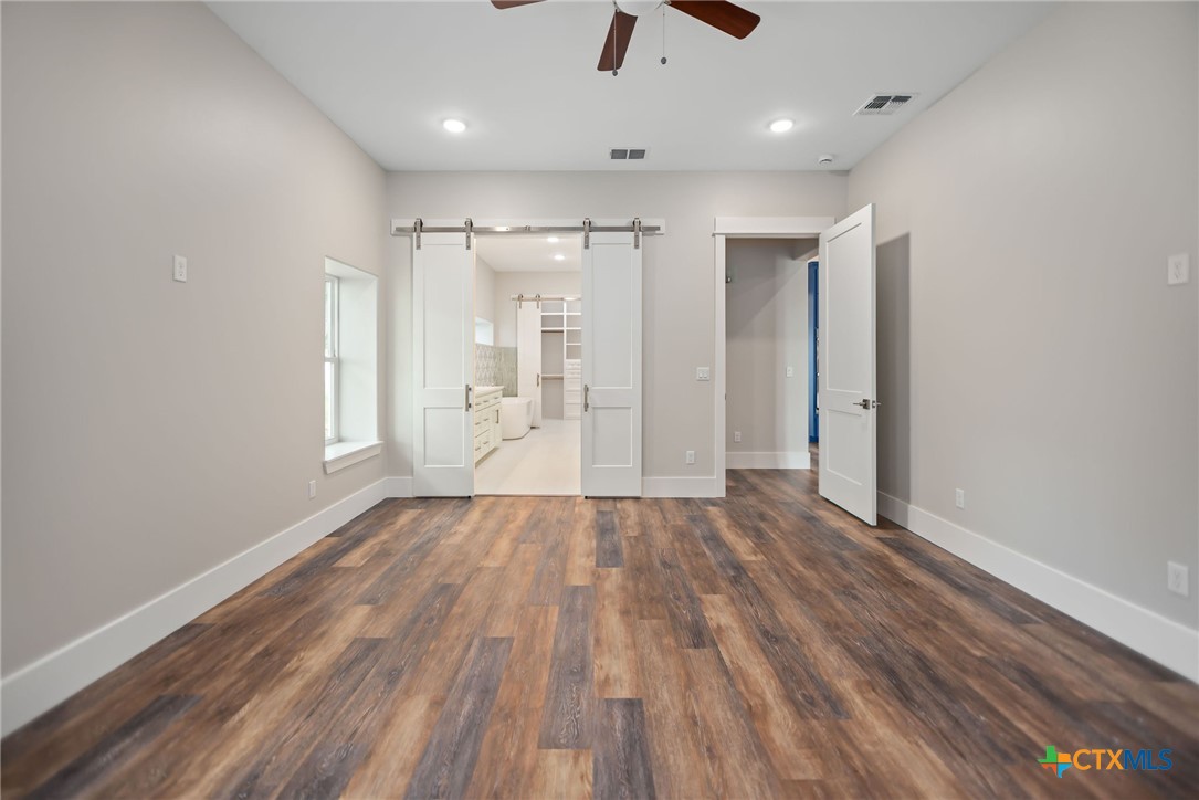 2062 Harrison Avenue Port O'Connor, TX 77982 - Photo 22 of 48 a view of an empty room with wooden floor