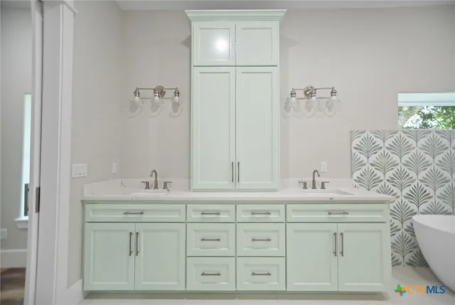 a bathroom with a sink vanity granite and a mirror