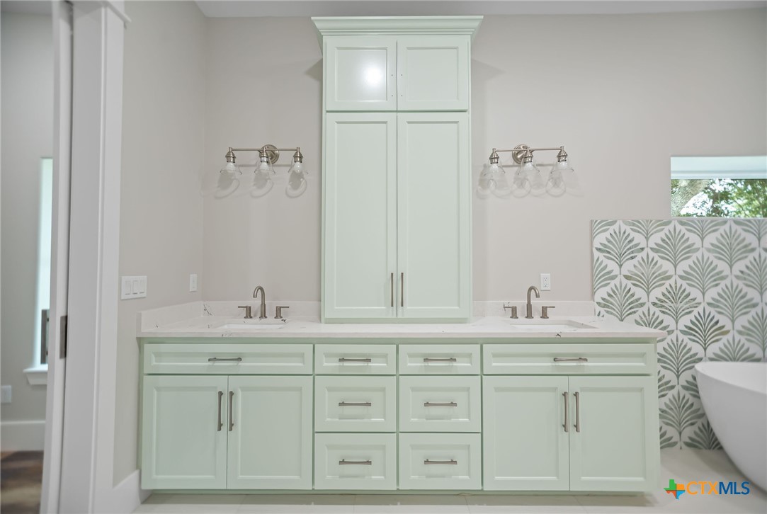 2062 Harrison Avenue Port O'Connor, TX 77982 - Photo 23 of 48 a bathroom with a sink vanity granite and a mirror