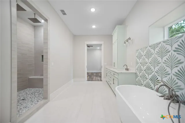 a spacious bathroom with a bathtub and shower