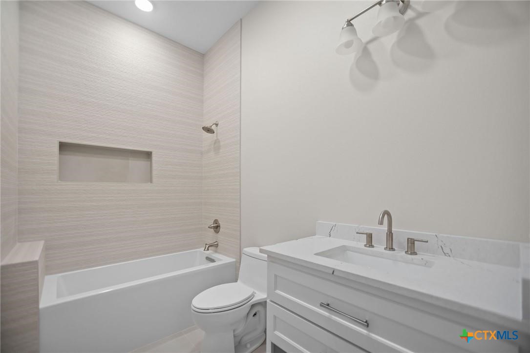 2062 Harrison Avenue Port O'Connor, TX 77982 - Photo 34 of 48 a bathroom with a sink a toilet and a bathtub