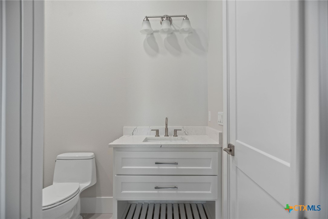 2062 Harrison Avenue Port O'Connor, TX 77982 - Photo 35 of 48 a bathroom with a sink toilet and vanity