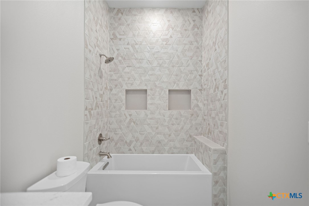 2062 Harrison Avenue Port O'Connor, TX 77982 - Photo 39 of 48 a bathroom with a bathtub and a shower