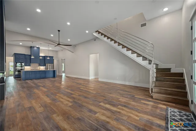 a view of a hallway with wooden floor