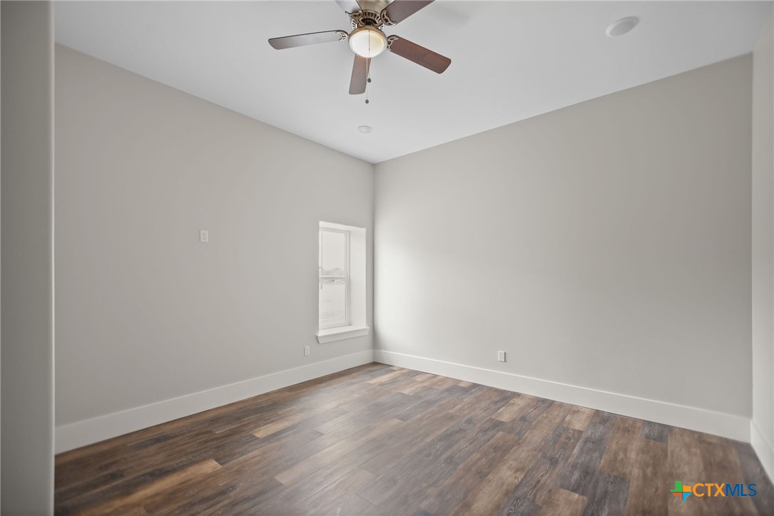 2062 Harrison Avenue Port O'Connor, TX 77982 - Photo 41 of 48 wooden floor in an empty room with a window