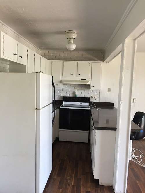 57 Vail Colony, Unit 2 Fox Lake, IL 60020 - Photo 2 of 12 a kitchen with a refrigerator a stove top oven and cabinets