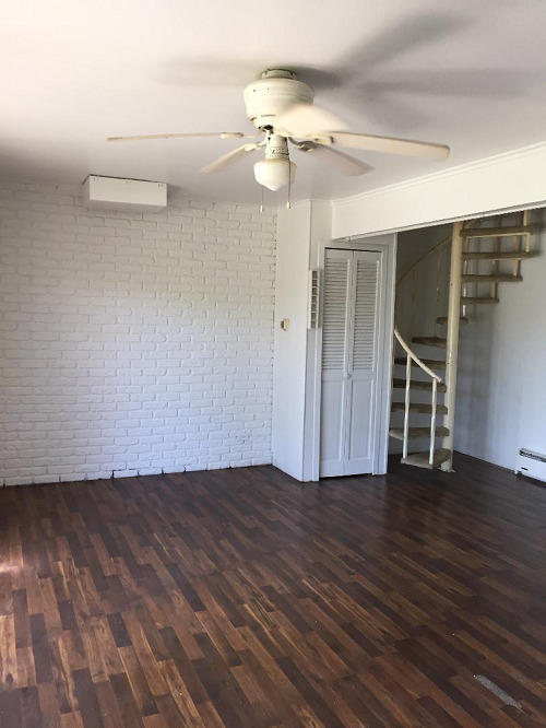 57 Vail Colony, Unit 2 Fox Lake, IL 60020 - Photo 6 of 12 a view of an empty room with wooden floor and a ceiling fan