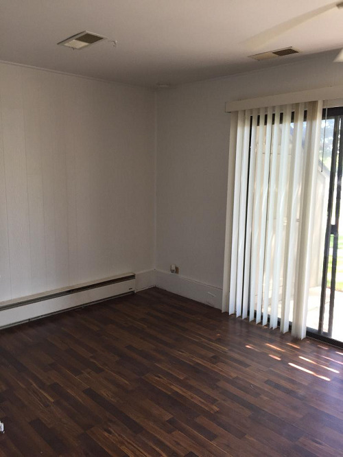 57 Vail Colony, Unit 2 Fox Lake, IL 60020 - Photo 9 of 12 an empty room with wooden floor and a window