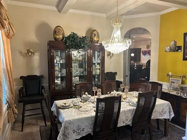 a view of a dining room with furniture and chandelier