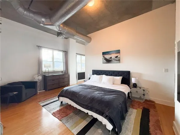 a bedroom with a bed window and dresser