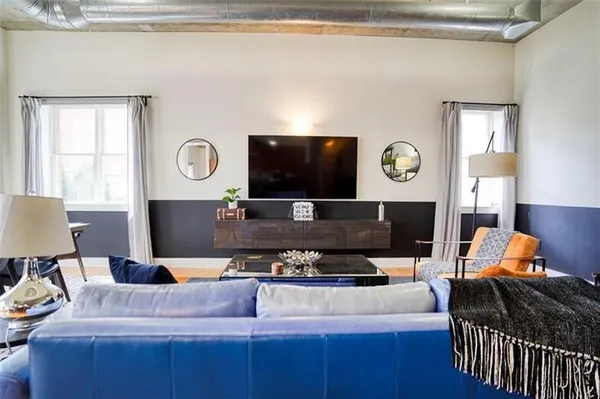 a living room with furniture and a flat screen tv