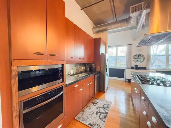 a kitchen with stainless steel appliances granite countertop a stove and a sink