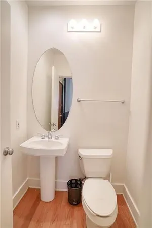 a white toilet sitting next to a bathroom sink