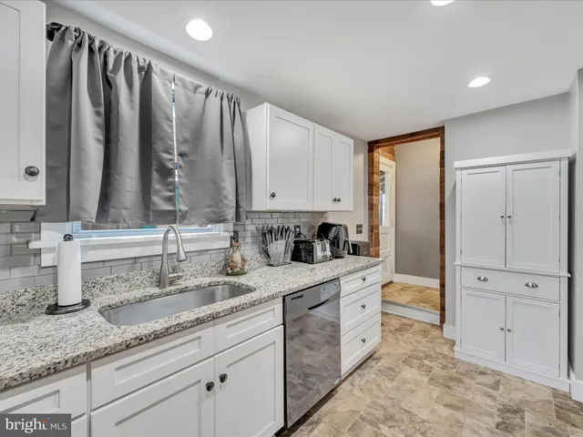 a bathroom with double vanity and a mirror
