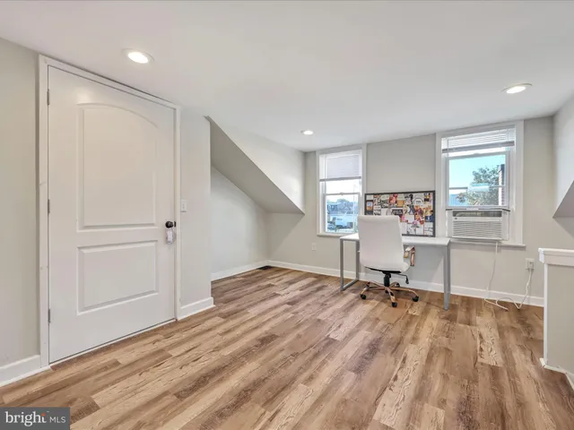a view of a room with a wooden floor and a sink