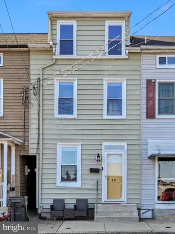 a view of a brick building with many windows