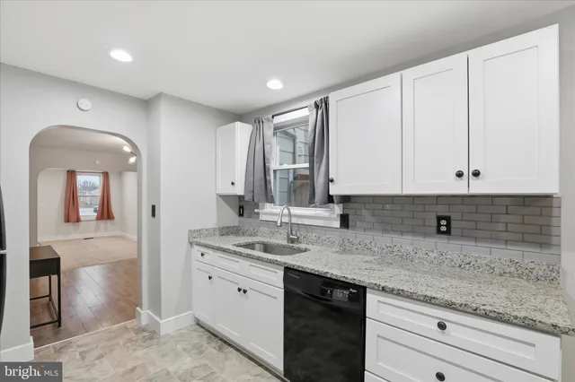 a kitchen with a refrigerator and a sink