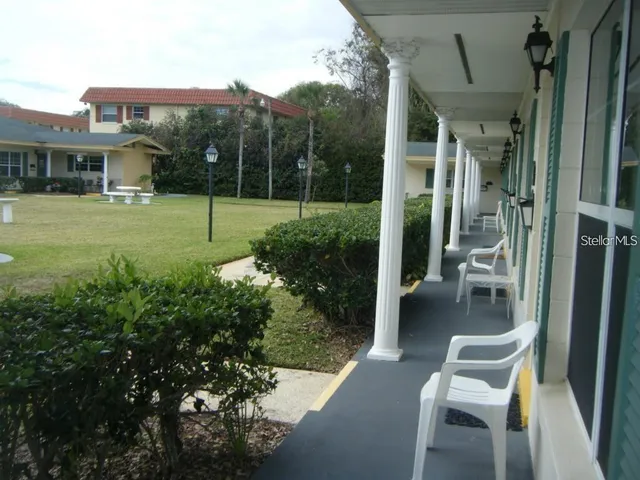 a view of a chair and tables in the balcony