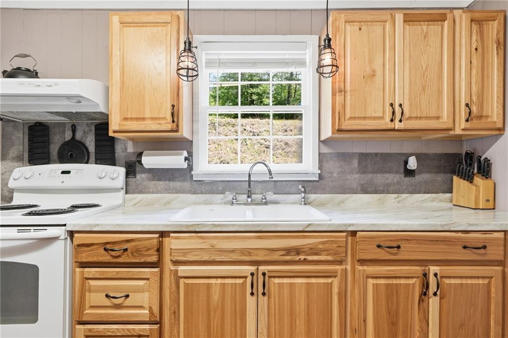 1709 Harrington Road Ball Ground, GA 30107 - Photo 11 of 46 a kitchen with granite countertop white cabinets and window