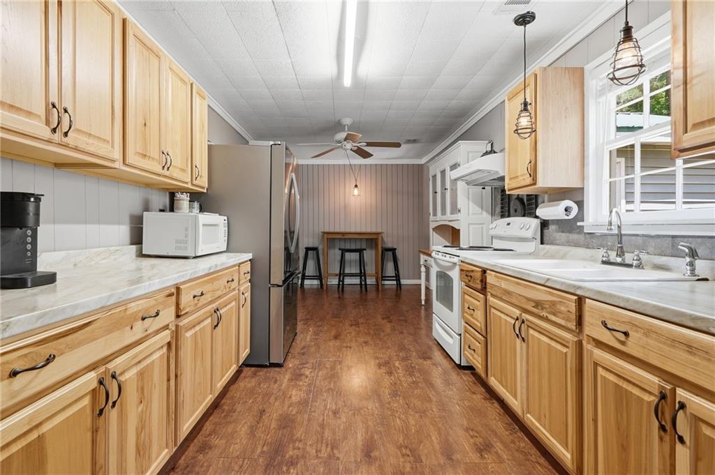 1709 Harrington Road Ball Ground, GA 30107 - Photo 13 of 46 a kitchen with sink cabinets and wooden floor