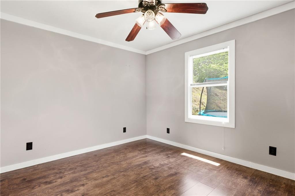 1709 Harrington Road Ball Ground, GA 30107 - Photo 17 of 46 an empty room with a window and a fan