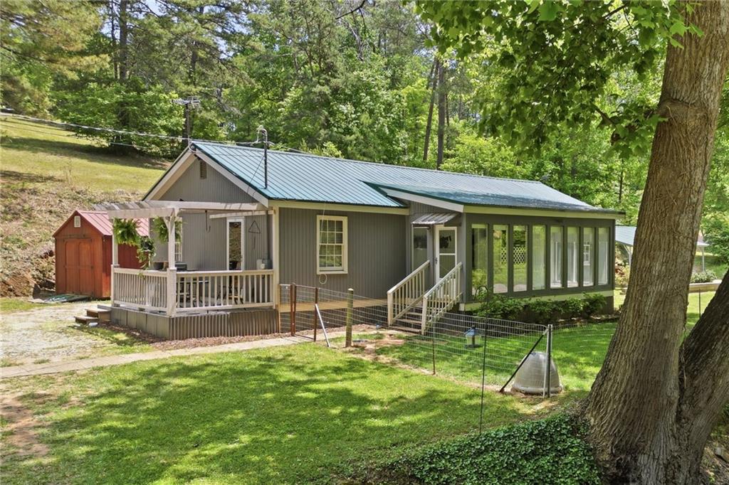 1709 Harrington Road Ball Ground, GA 30107 - Photo 2 of 46 a backyard of a house with barbeque oven table and chairs