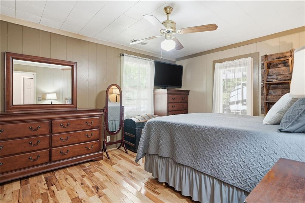 1709 Harrington Road Ball Ground, GA 30107 - Photo 22 of 46 a bedroom with a large bed and a tv